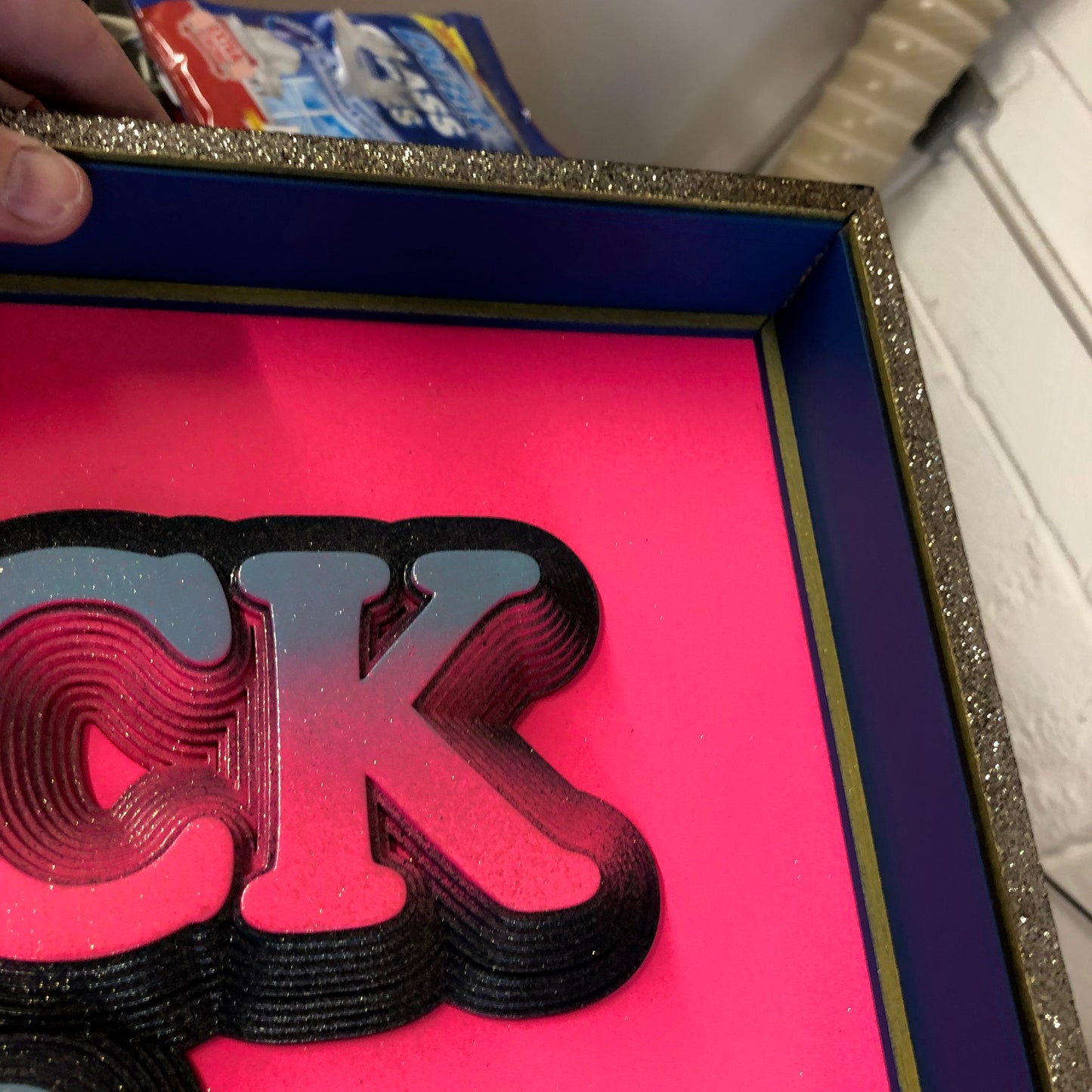 Multiple layered laser cuts finished in hot pink and glitter with a glossy varnish. Built in to a hand made box frame in complimentary colours. pop art cooper font rock and roll maximalist artwork wallart