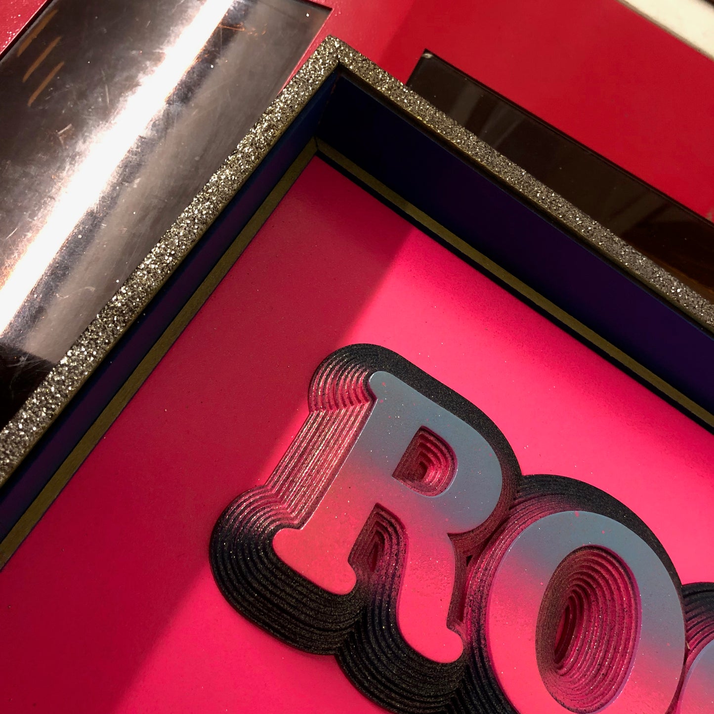 Multiple layered laser cuts finished in hot pink and glitter with a glossy varnish. Built in to a hand made box frame in complimentary colours. pop art cooper font rock and roll maximalist artwork wallart