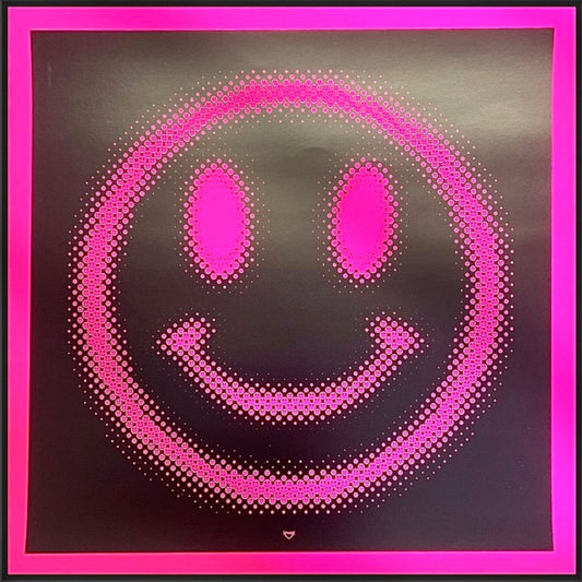 Framed artwork of a pink smiley face with a black border on a white wall.